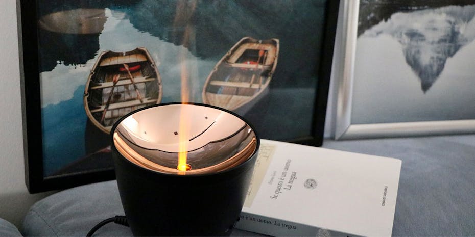Zoe aroma diffuser by Stadler Form in black with flame effectas decoration