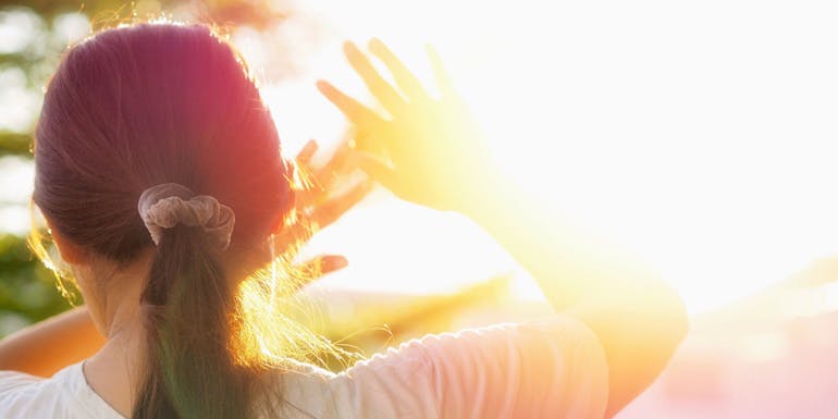 Woman protects herself from sunlight Woman protects herself from sunlight