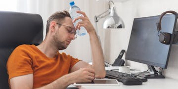 Man working while sweating