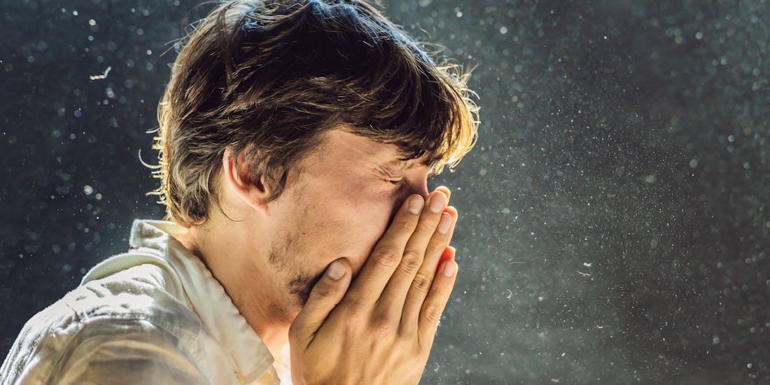 Young man sneezes in the dust Young man sneezes in the dust