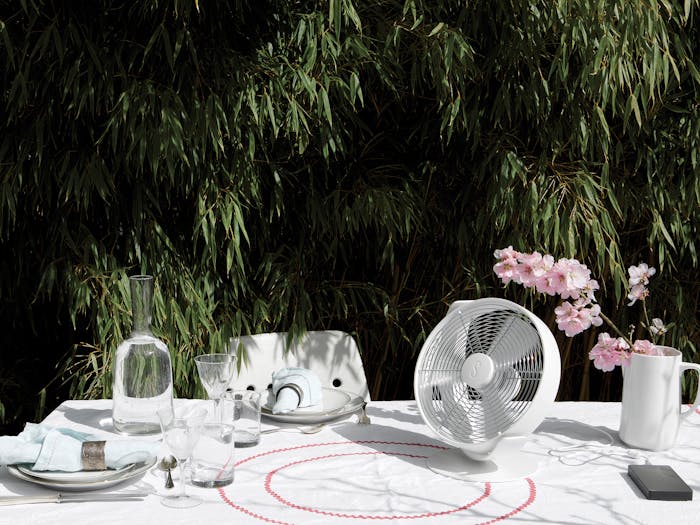 Tim table fan by Stadler Form in white on a outdoor dining table