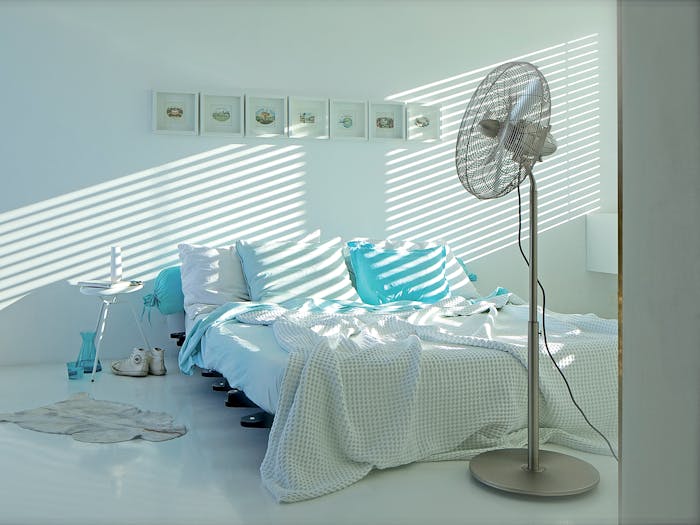 Charly stand fan by Stadler Form in a bedroom
