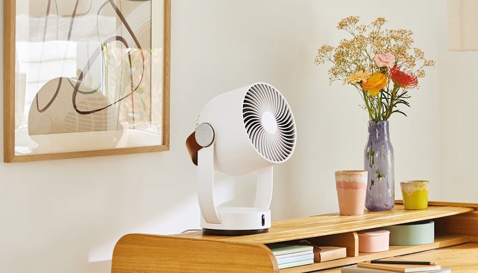 Leo fan by Stadler Form on a table with flowers