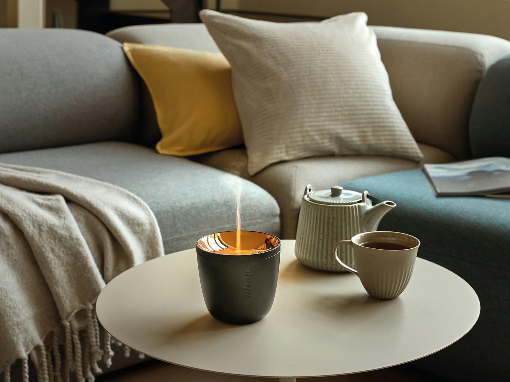 Zoe mobile aroma diffuser in black on a coffee table