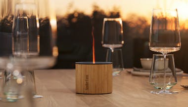 Nora aroma diffuser from Stadler Form on a dining table outside