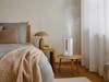 Oliver humidifier by Stadler Form in a bedroom on a little table
