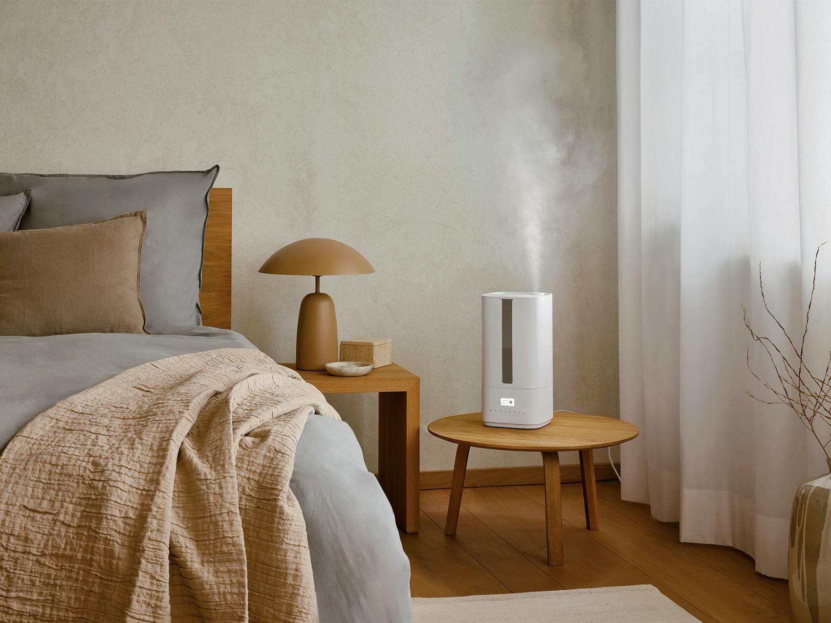 Oliver humidifier by Stadler Form in a bedroom on a little table