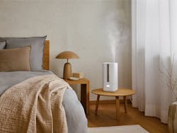 Oliver humidifier by Stadler Form in a bedroom on a little table
