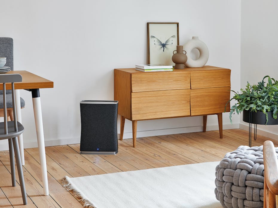 Roger little air purifier by Stadler Form in black next to a sideboard