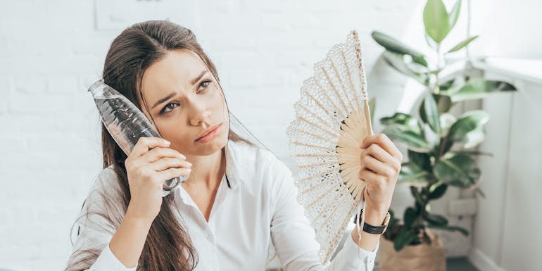 Woman has too hot at work and tries to cool herself down