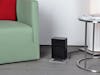 Anna little heater by Stadler Form in black in a living room
