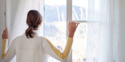 Woman looks out the window
