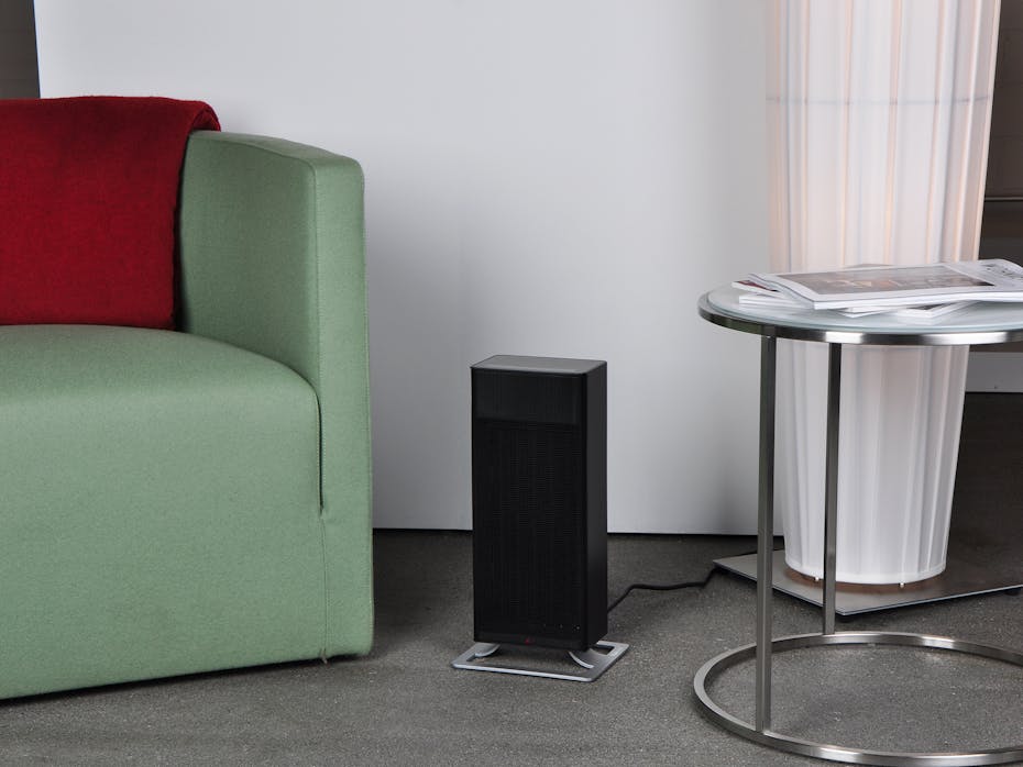 Anna heater by Stadler Form in black in a living room