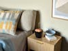 Zoe mobile aroma diffuser in black on a bedside table